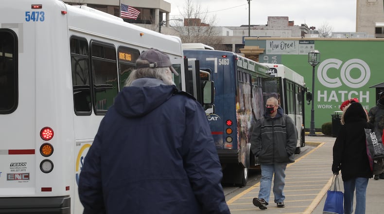 Riders get on and off the SCAT buses at the bus center in downtown Springfield. BILL LACKEY/STAFF