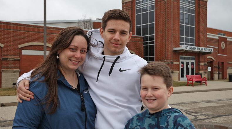 Rachel Suther, with her sons, Nathan Arnold, 18, and Darren Suther, 11. Both are attending school in the Tecumseh Local School District. BILL LACKEY/STAFF