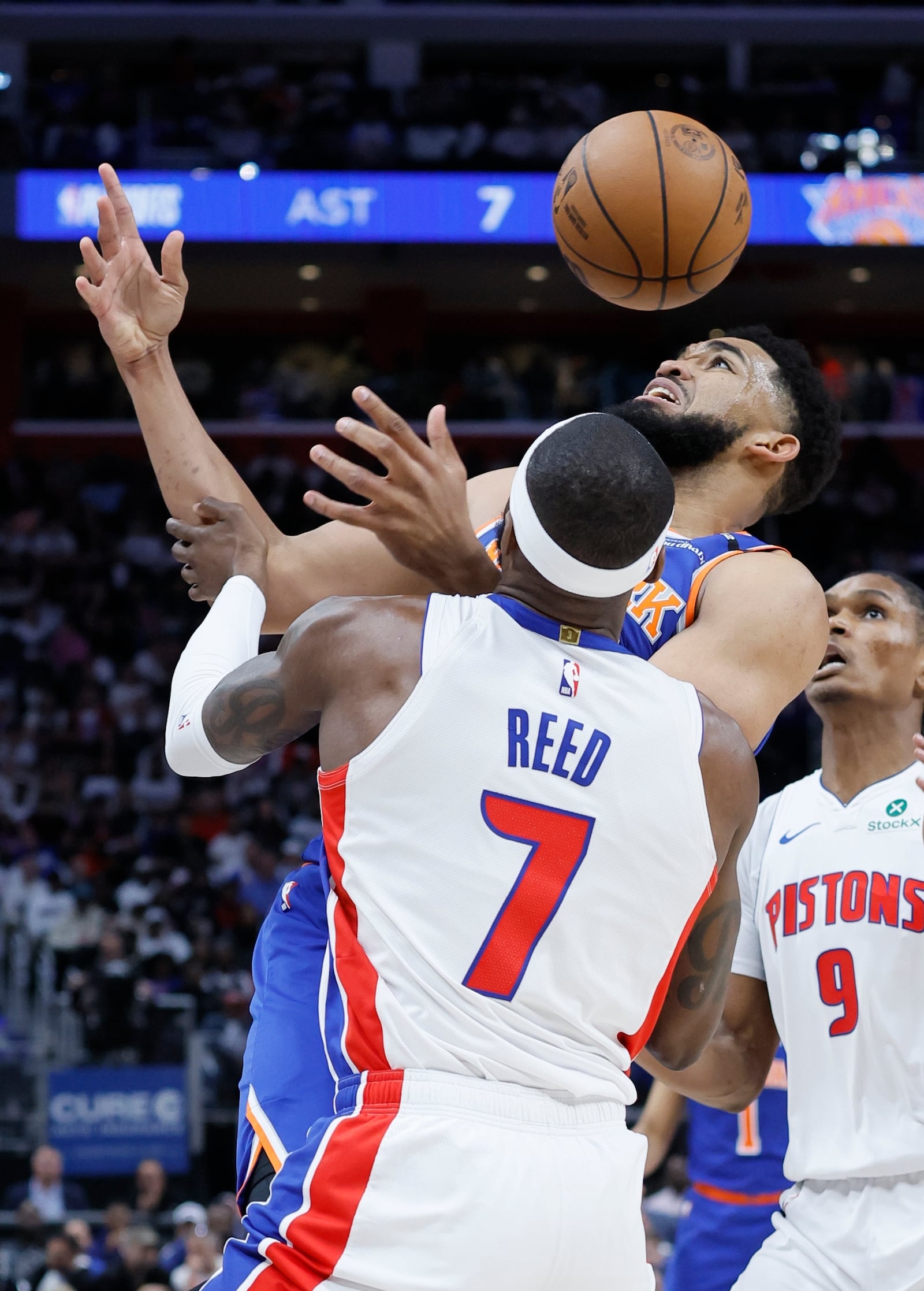 New York Knicks center Karl-Anthony Towns, top, has the ball knocked away by Detroit Pistons forward Paul Reed (7) during the first half of Game 6 of an NBA basketball first-round playoff series Thursday, May 1, 2025, in Detroit. (AP Photo/Duane Burleson)