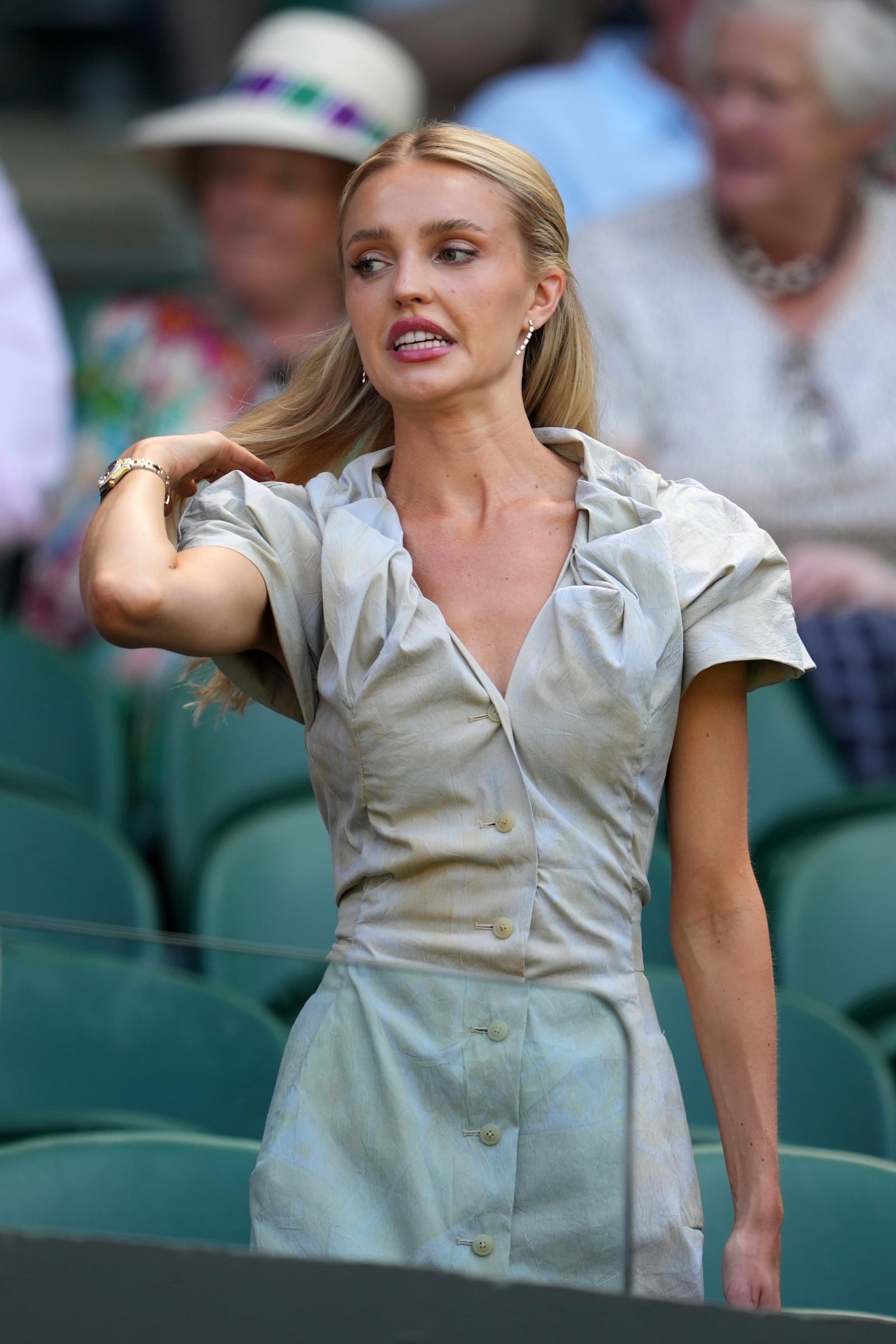 Morgan Riddle the girlfriend of Taylor Fritz of the U.S. arrives to take her seat before her boyfriend plays Spain's Carlos Alcaraz in a men's singles semifinal at the Wimbledon Tennis Championships in London, Friday, July 11, 2025. (AP Photo/Kin Cheung)