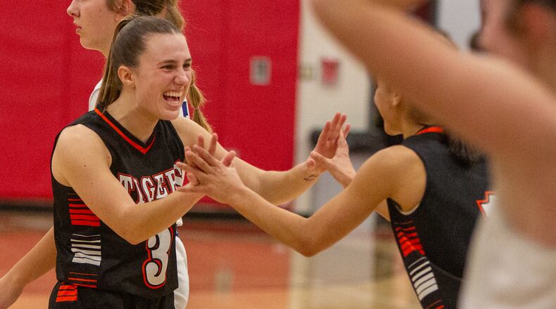 West Liberty-Salem's Megan Hollar celebrates with teammate Lilly Weaver after Friday's victory over Miami East in a Division III tournament game at Northridge High School. Jeff Gilbert/CONTRIBUTED
