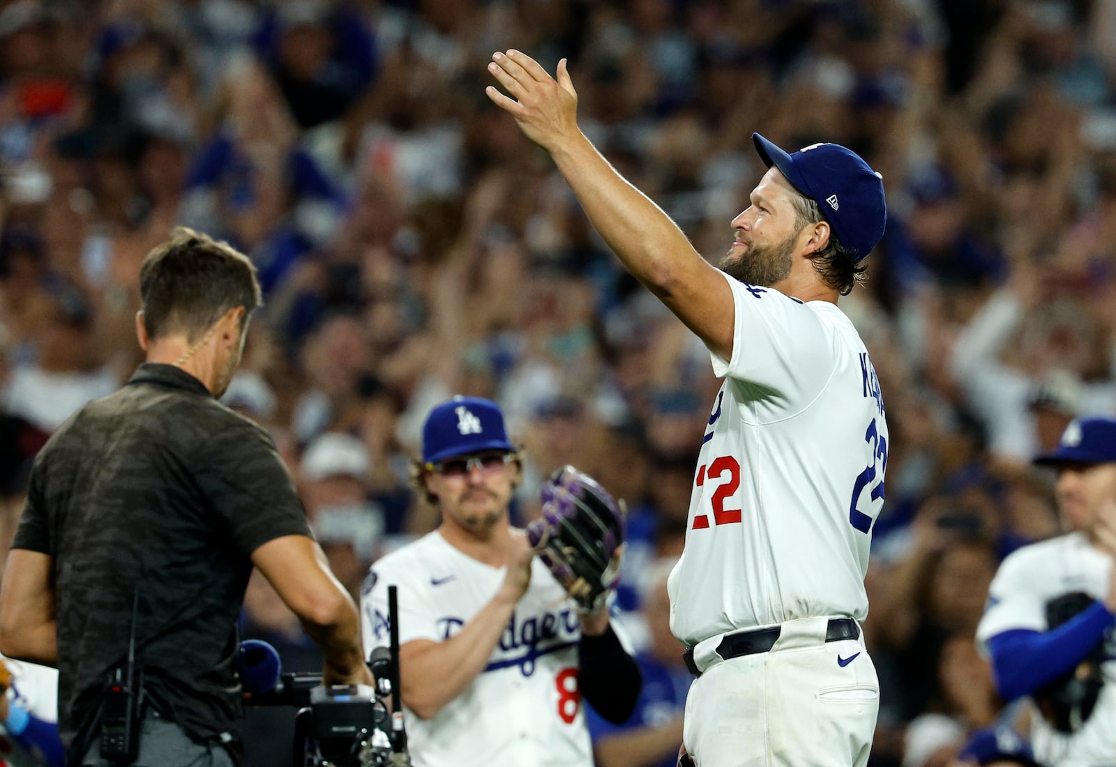 Los Angeles Dodgers pitcher Clayton Kershaw, right, blows a kiss to his family in the stands after recording his 3,000th career strikeout during the sixth inning of a baseball game against Chicago White Sox Wednesday, July 2, 2025, in Los Angeles. (AP Photo/Kevork Djansezian)