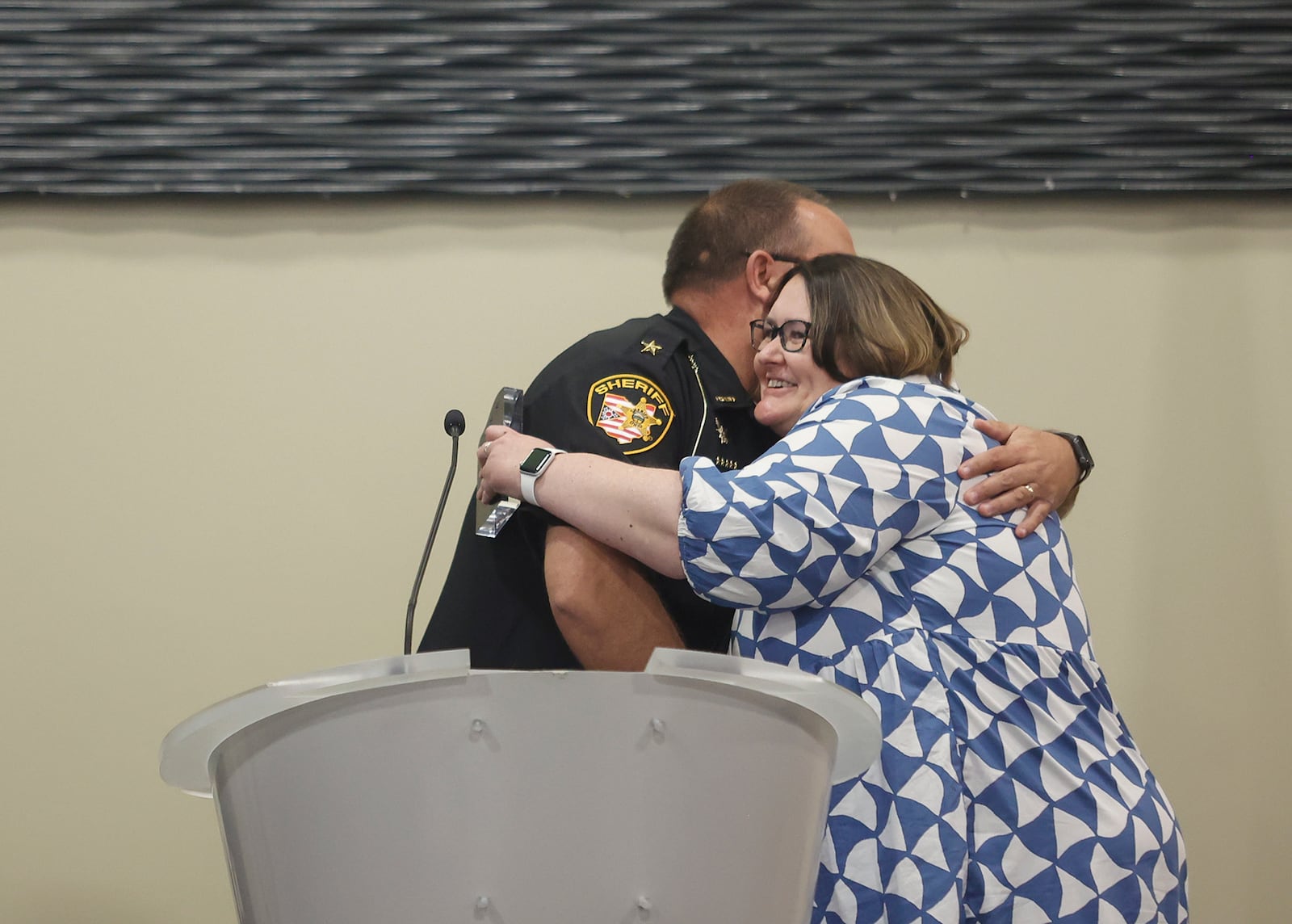 Clark County Sheriff Admin Assistant Angie Lyons, right, hugs Clark County Sheriff Chris Cook as she's recognized at the Springfield Rotary Club's Service Above Self Awards on Monday, May 19, 2025, at Hollenbeck Bayley Center. JOSEPH COOKE/STAFF