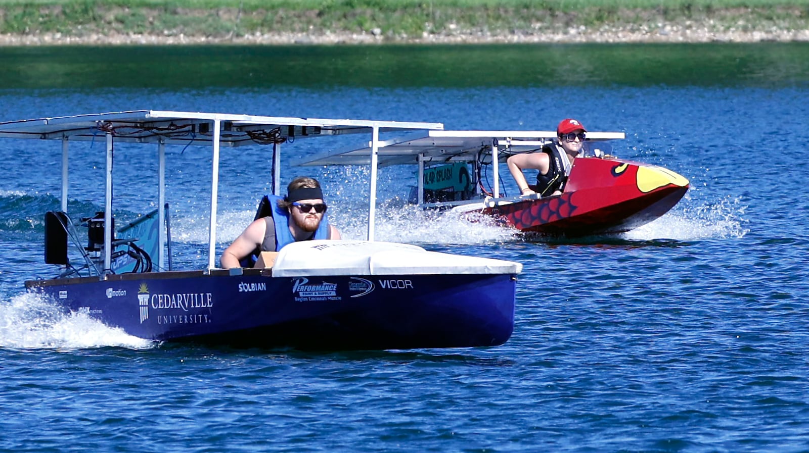Kaden Torgerud, a student at Cedarville University, pilots his school's solar boat during one of the sprint heat against the University of Southern Indiana at Solar Splash 2024 Friday. Teams from eight colleges, from as far away as the University of Puerto Rico, participated in this years event at Champions Park Lake. Solar Splash, in its 30th year, is the World Championship of Collegiate Solar Boat racing. The five day event starts on June 4 and features five on-the-water competitive events, the solar slalom, the solar endurance and the solar sprint. BILL LACKEY/STAFF