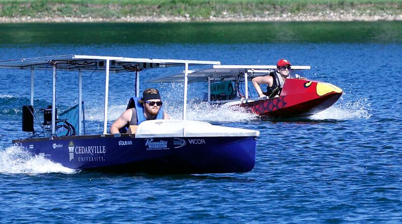 Kaden Torgerud, a student at Cedarville University, pilots his school's solar boat during one of the sprint heat against the University of Southern Indiana at Solar Splash 2024 Friday. Teams from eight colleges, from as far away as the University of Puerto Rico, participated in this years event at Champions Park Lake. Solar Splash, in its 30th year, is the World Championship of Collegiate Solar Boat racing. The five day event starts on June 4 and features five on-the-water competitive events, the solar slalom, the solar endurance and the solar sprint. BILL LACKEY/STAFF
