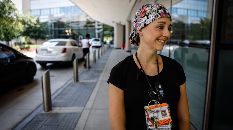 “We’ve already opened up a second
Lindsey Call is an ICU nurse at Miami Valley Hospital. “We’re on the verge of opening a third. So that just tells you the increase in numbers just in this past week or two. JIM NOELKER/STAFF