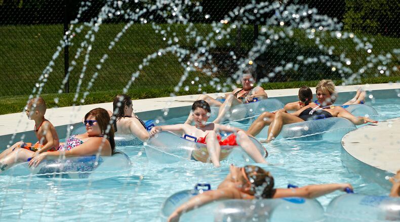 Swimmers at the Kroger Aquatics Center at The Heights float around the Lazy River on a warm Tuesday afternoon. The parking lot of the water park was almost full by noon.