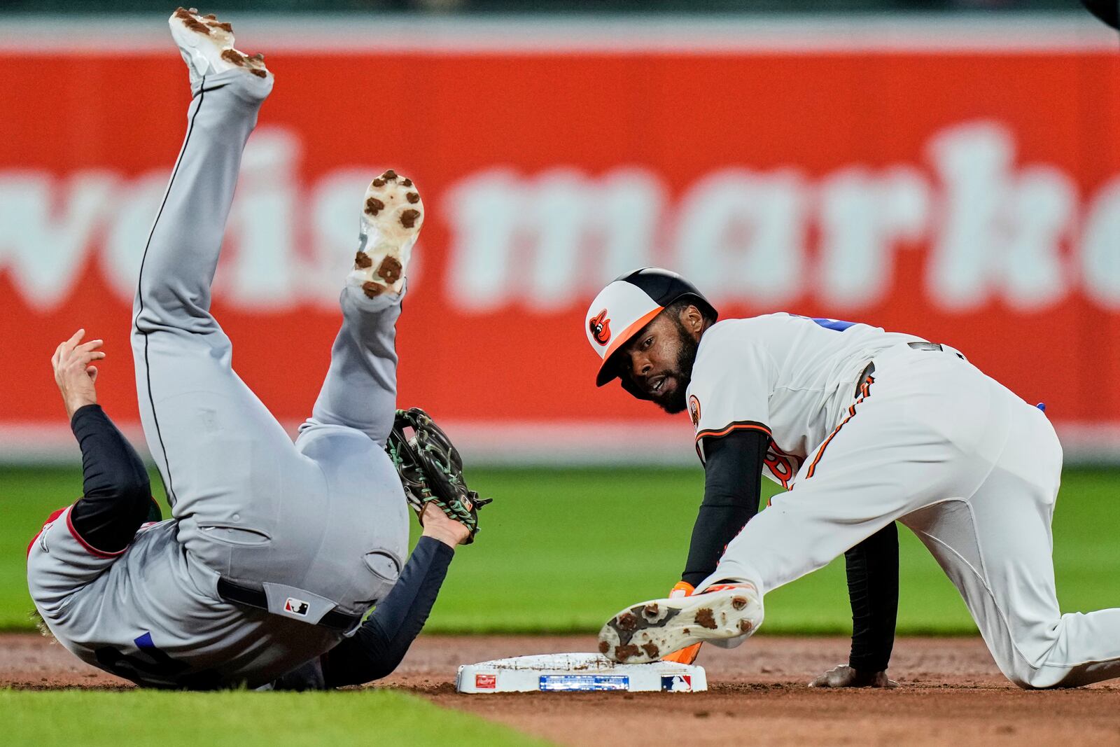 Baltimore Orioles' Cedric Mullins, right, steals second base in front of Cleveland Guardians third baseman Gabriel Arias, left, during the third inning of a baseball game, Tuesday, April 15, 2025, in Baltimore. (AP Photo/Stephanie Scarbrough)