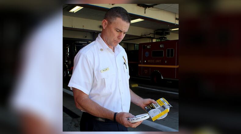 Springfield’s new Fire Chief Brian Miller holds one of the new, 10-year-battery-life smoke detectors the station wants to install for free in senior citizens homes. JEFF GUERINI/STAFF