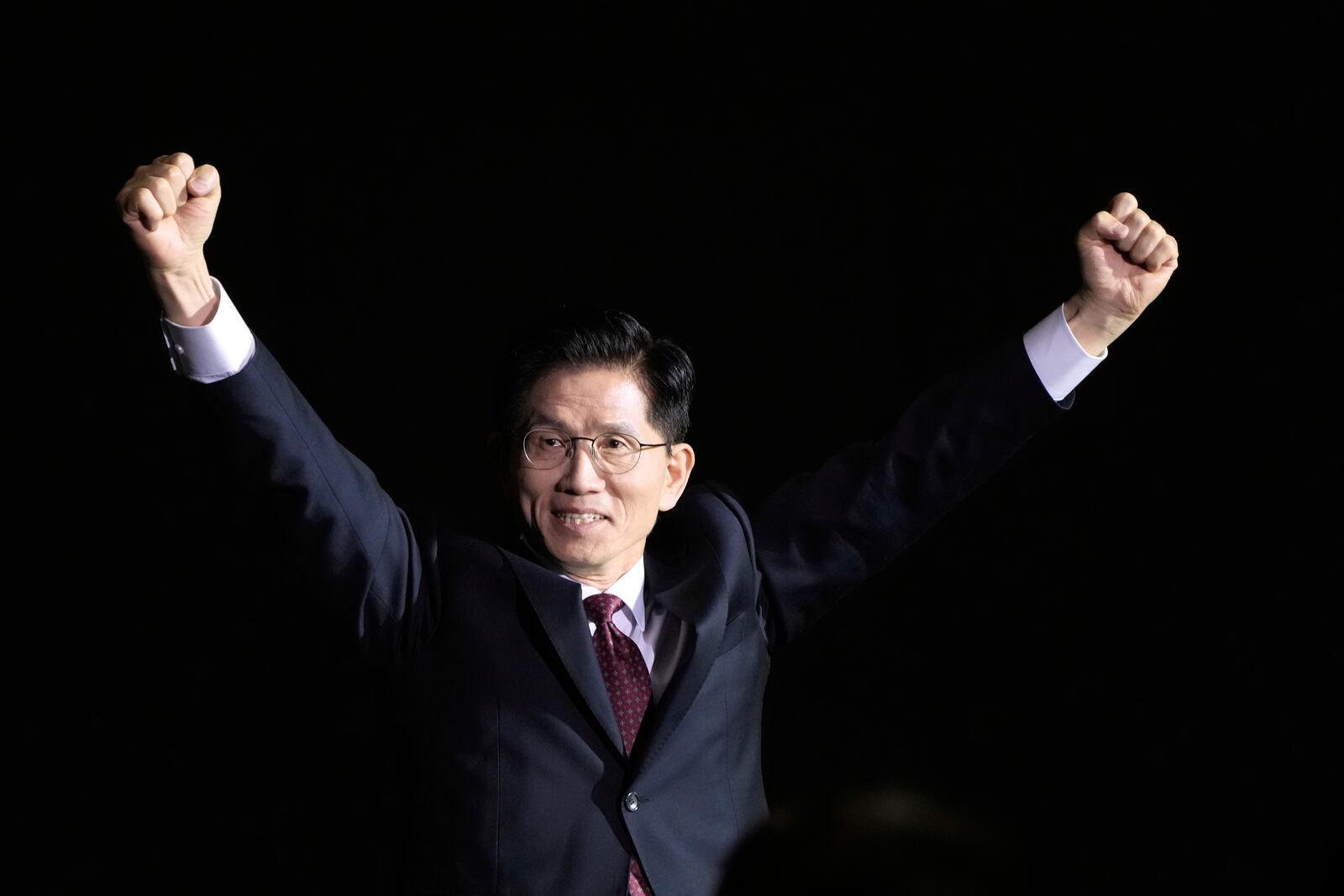 South Korea's former Labor Minister Kim Moon Soo raises his hands as he arrives to attend the People Power Party's convention in Goyang, South Korea, Saturday, May 3, 2025. (AP Photo/Ahn Young-joon)