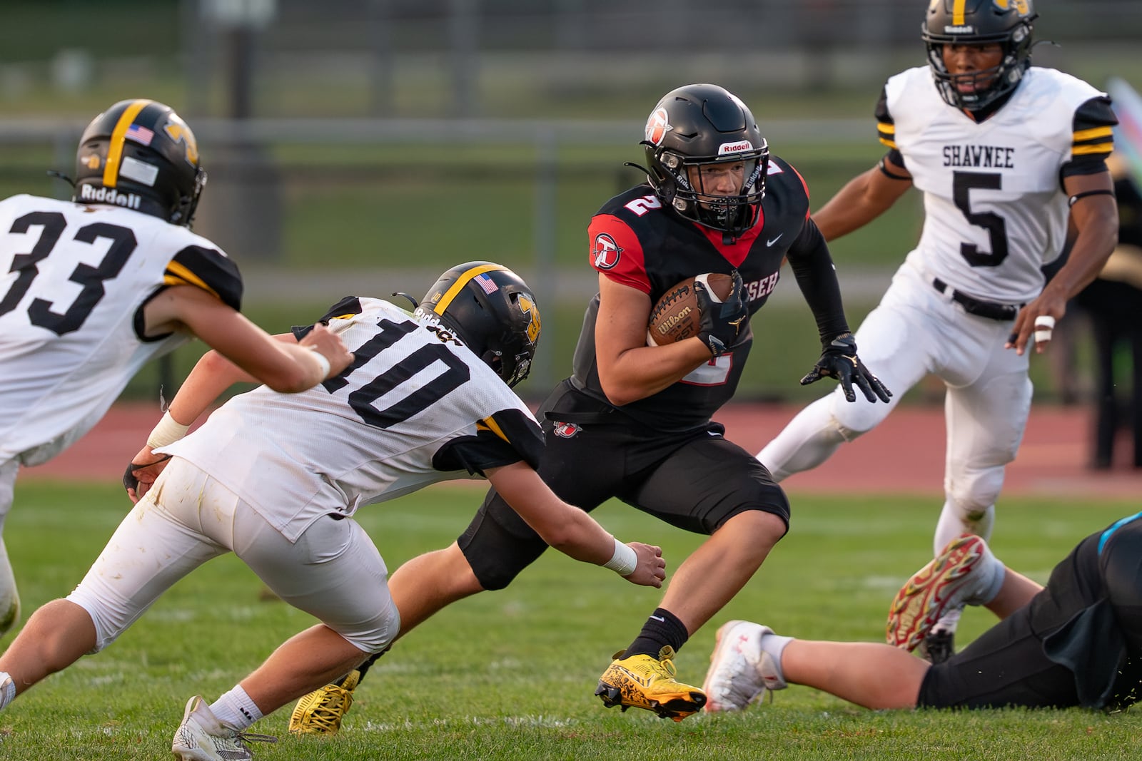 Tecumseh High School's Noah Carl runs past several Shawnee defenders during their game on Friday, Sept. 5 at Spitzer Stadium in New Carlisle. The Arrows beat Shawnee 14-12. RODNEY GETZ/CONTRIBUTED PHOTO