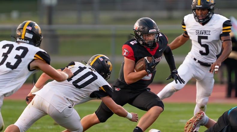 Tecumseh High School's Noah Carl runs past several Shawnee defenders during their game on Friday, Sept. 5 at Spitzer Stadium in New Carlisle. The Arrows beat Shawnee 14-12. RODNEY GETZ/CONTRIBUTED PHOTO
