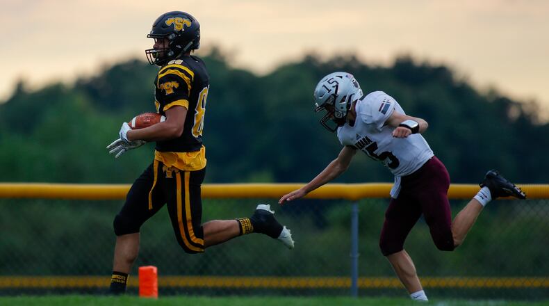 Shawnee High School senior Evan Thomas is chased by Urbana High School freshman Will Donahoe as he runs into the end zone after picking up a fumble on Friday night in Springfield. The Braves won 40-3. Michael Cooper/CONTRIBUTED