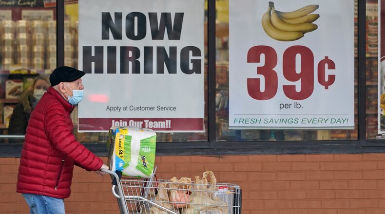 FILE - A man walks out of a Marc's Store,  Friday, Jan. 8, 2021, in Mayfield Heights, Ohio.  Fewer Americans applied for unemployment benefits last week, lowering claims to 900,000, still a historically high level that points to further job cuts in a raging pandemic. (AP Photo/Tony Dejak, file)