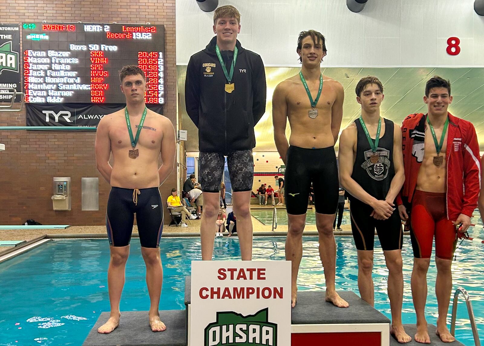 Kenton Ridge senior Evan Blazer stands atop the podium after winning a Division II state title Friday in the 50-yard freestyle. It was the first individual state title in school history. CONTRIBUTED