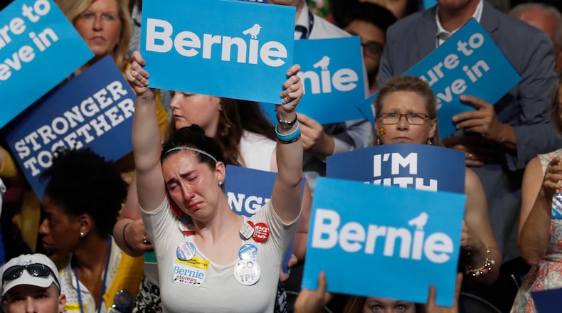 A disappointed supporter for Former Democratic presidential candidate, Sen. Bernie Sanders, I-Vt., holds up her sign during the first day of the Democratic National Convention in Philadelphia , Monday, July 25, 2016. (AP Photo/Mary Altaffer)