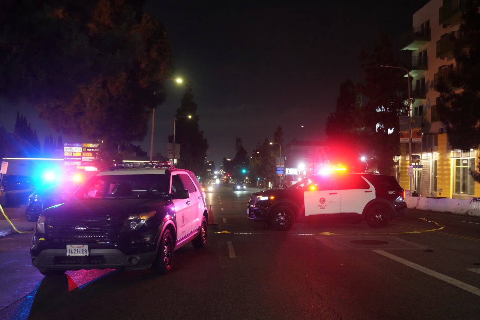 Police patrol vehicles close Vermiont Ave. after a vehicle rammed into a crowd gathered outside "The Vermont" nightclub in Los Angeles, early morning Saturday, July 19, 2025. (AP Photo/Damian Dovarganes)