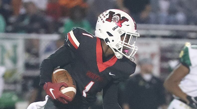Wayne's RJ Mukes carries the ball against Northmont. BILL LACKEY/STAFF