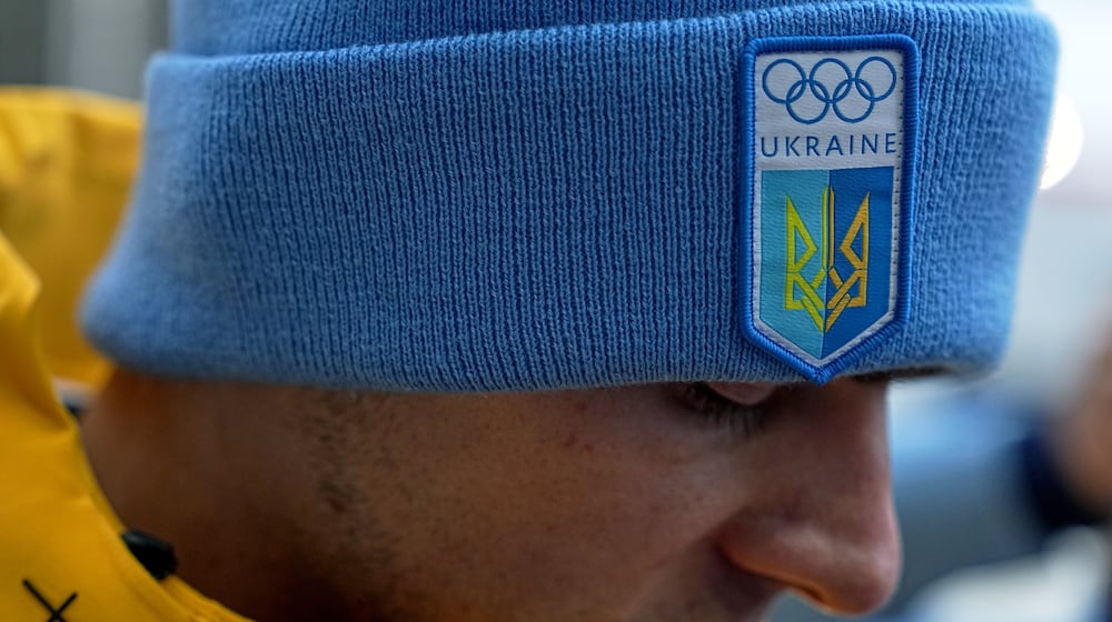 Ukrainian skeleton athlete Vladyslav Heraskevych talks to the media at the start house of the sliding center at the 2026 Winter Olympics, in Cortina d'Ampezzo, Italy, Thursday, Feb. 12, 2026. (AP Photo/Fatima Shbair)