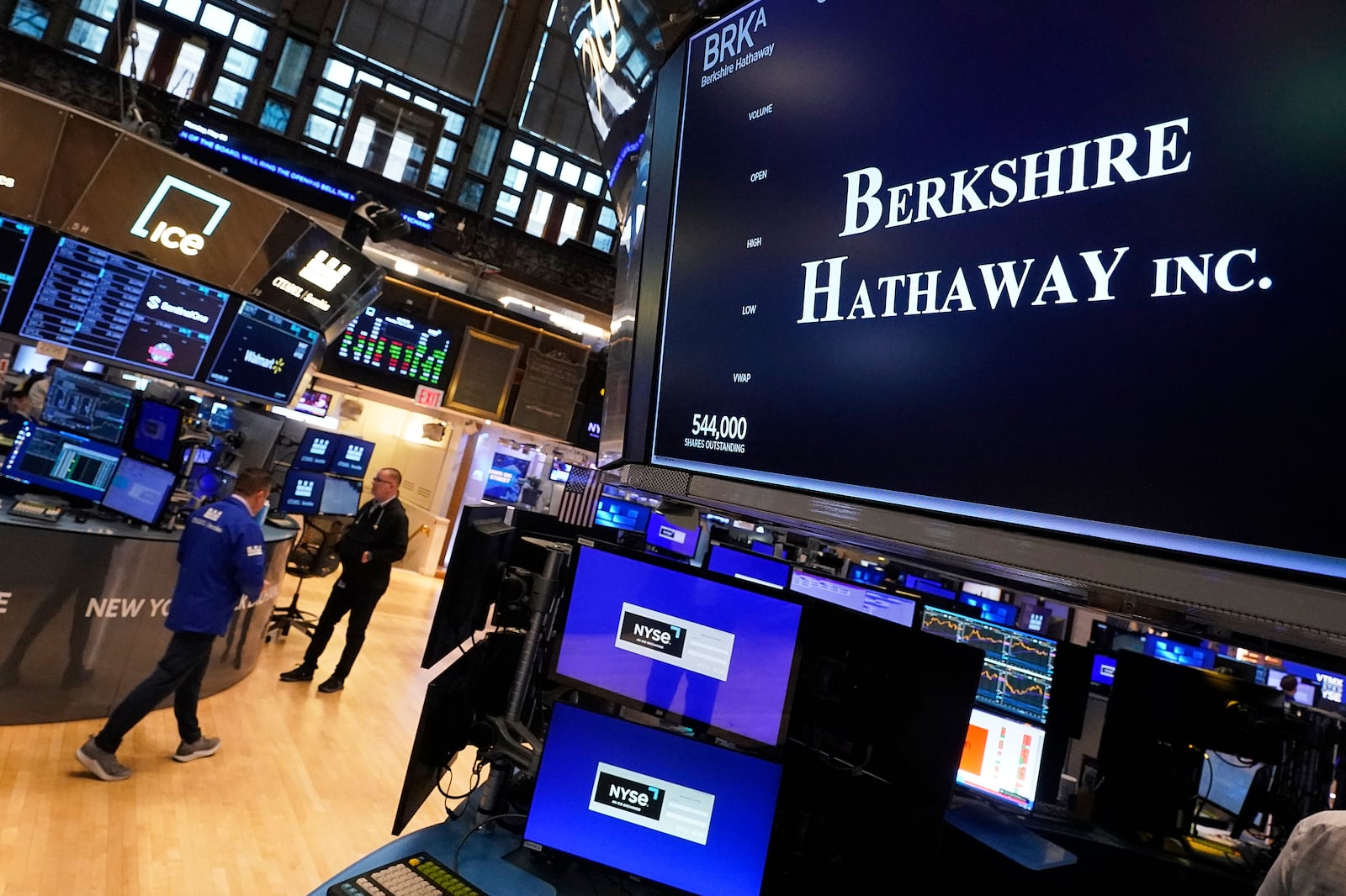 The logo for Berkshire Hathaway Inc. appears above a trading post on the floor of the New York Stock Exchange, Monday, May 5, 2025. (AP Photo/Richard Drew)