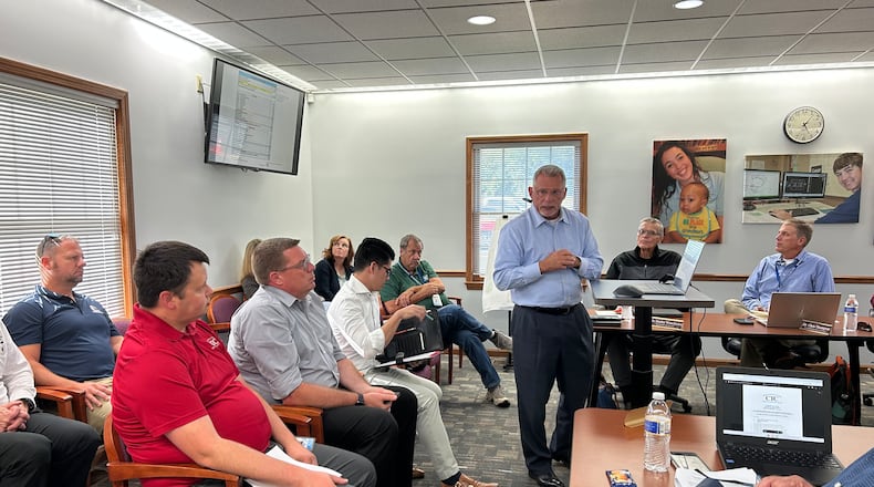 Tony Schorr (middle, standing), principal architect and president of Schorr Architects, which is working on the new Springfield-Clark Career Technology Center (CTC) facility talked to school officials and partners about the project at the Aug. 26 special meeting. Brooke Spurlock/Staff