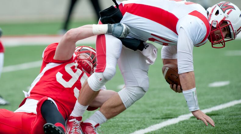 Miami defensive lineman Bryson Albright (red) tackles quarterback Austin Boucher (white) at the University of Miami Redhawks Football Scrimmage at Yager Stadium in Oxford, Ohio on Saturday, April 13. PHOTO CONTRIBUTED BY PAT STRANG