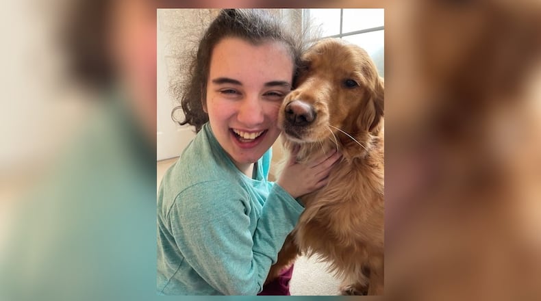 Mimi Sodano hugs her dog, Molly. Mimi requires specialized care because of a rare neurodevelopmental disorder. Photo provided by Lindsey Sodano.