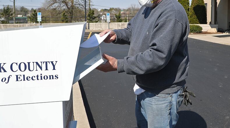 William Griffith places his absentee ballots in the dropbox in front of the Clark County Board of Elections at Springfield Government Center Wednesday. BILL LACKEY/STAFF