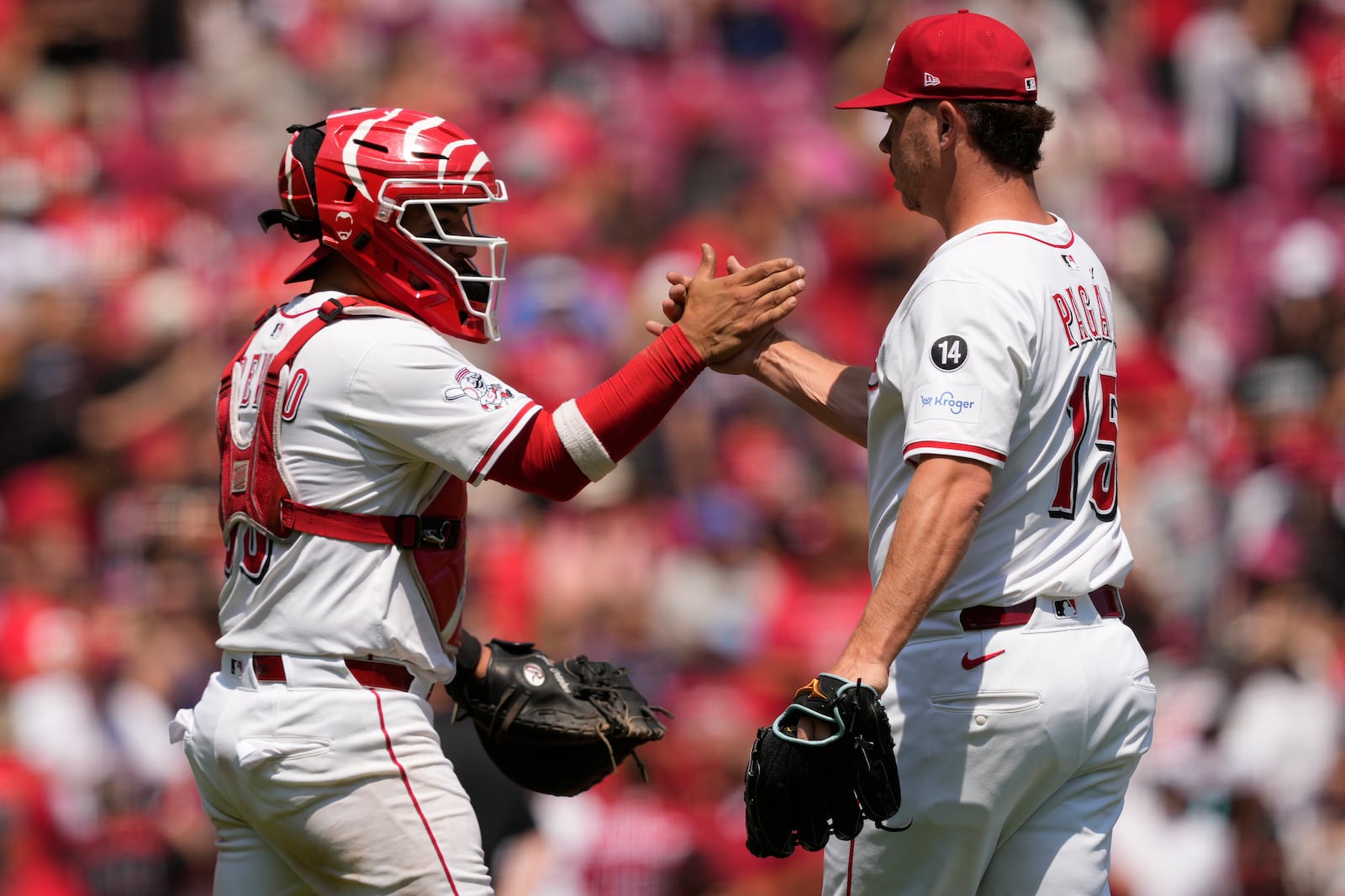 Cincinnati Reds pitcher Emilio Pagán, right, and cather Jose Trevino, left, celebrate winning a baseball game against the Atlanta Braves, Friday, Aug. 1, 2025, in Cincinnati. (AP Photo/Carolyn Kaster)