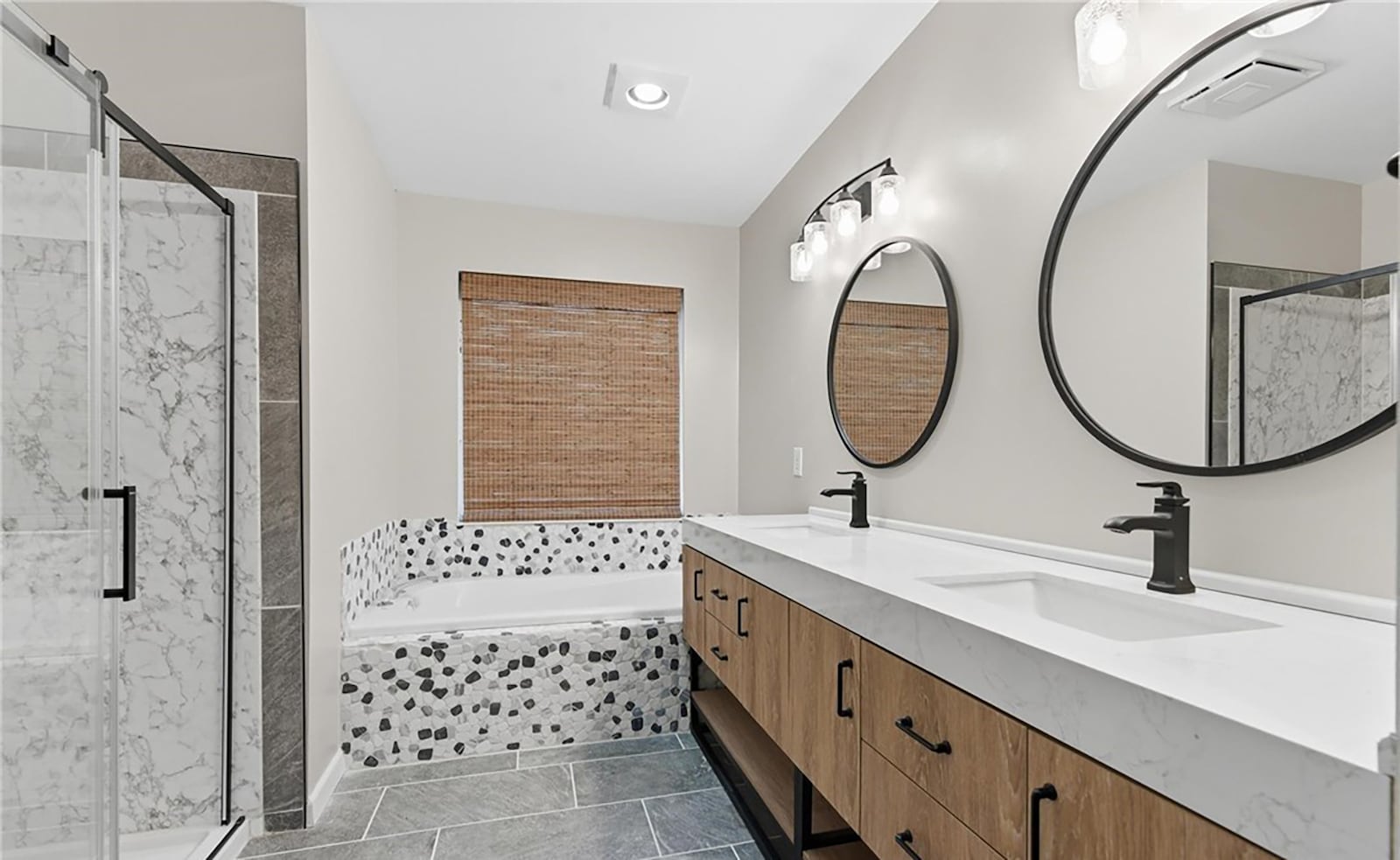 The primary ensuite bathroom has been completely remodeled and has tile flooring, a soaking tub, walk in shower with glass doors and a double vanity. CONTRIBUTED