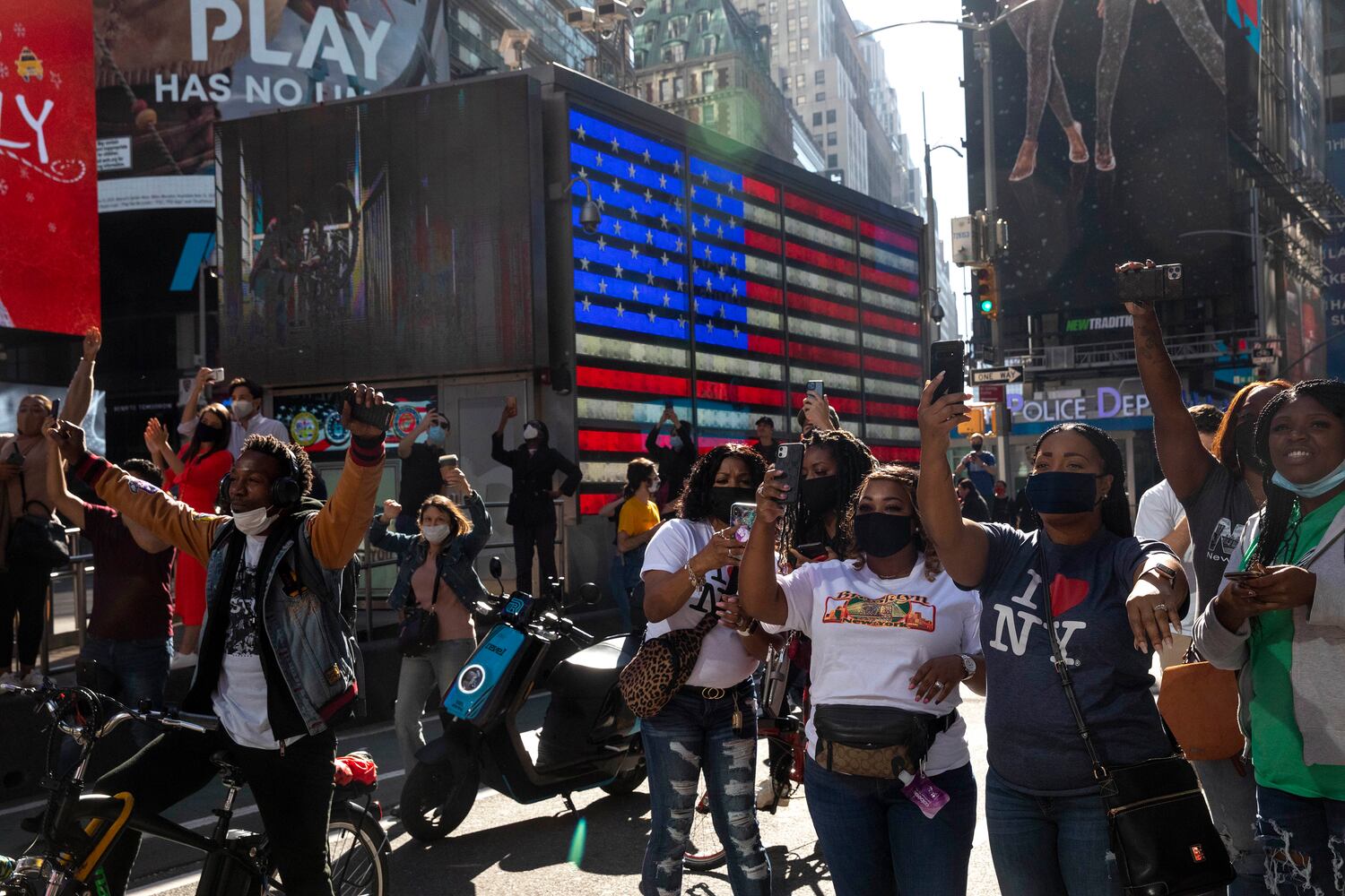 People react after it was announced that Joe Biden was elected the 46th president of the United States, on Saturday, Nov. 7, 2020, in New York. President-elect Biden achieved victory offering a message of healing and unity. He will return to Washington facing a daunting set of crises. (Dave Sanders/The New York Times)