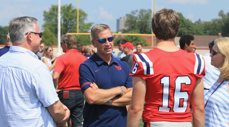 Offensive coordinator Jim Collins talks to the family of quarterback Spencer Hawkins at Dayton Flyers football photo day at Welcome Stadium on Sunday, Aug. 22, 2021. David Jablonski/Staff
