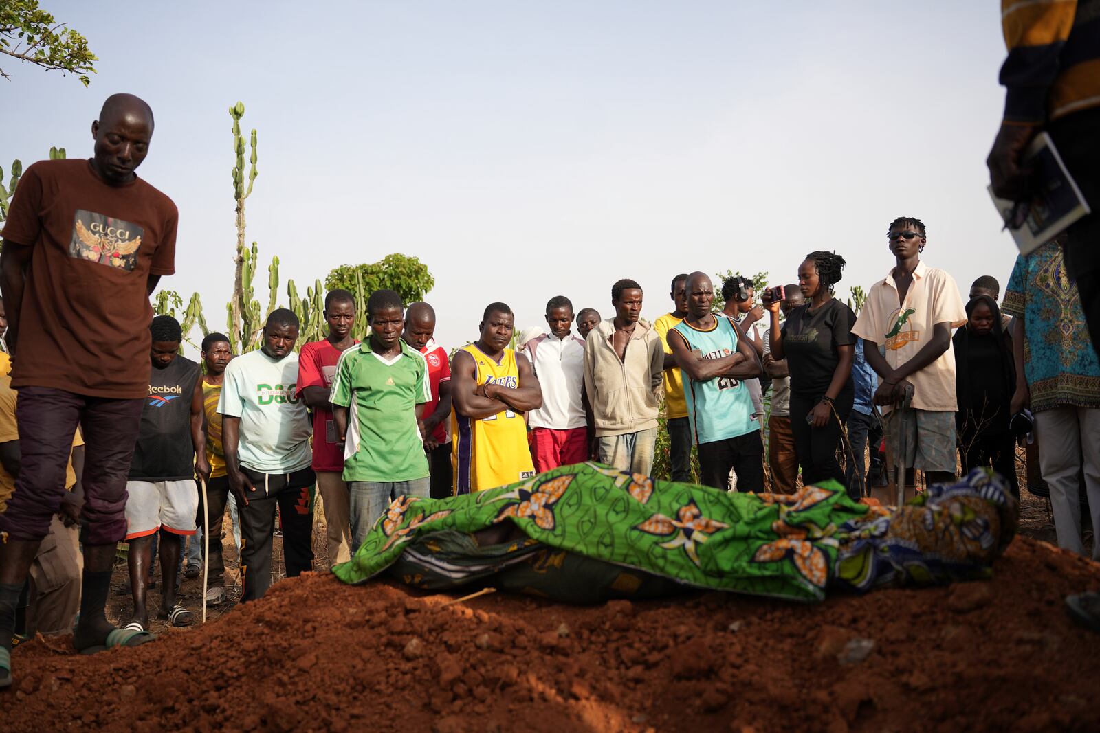 People attend the funeral of a man that was killed following an attack by gunmen in the Zike farming community in north-central Nigeria, Tuesday, April 15, 2025. (AP Photo/Samson Omale)
