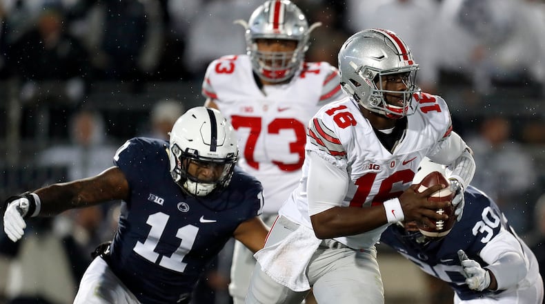 STATE COLLEGE, PA - OCTOBER 22:  J.T. Barrett #16 of the Ohio State Buckeyes is hurried by Brandon Bell #11 of the Penn State Nittany Lions in the first half during the game on October 22, 2016 at Beaver Stadium in State College, Pennsylvania.  (Photo by Justin K. Aller/Getty Images)