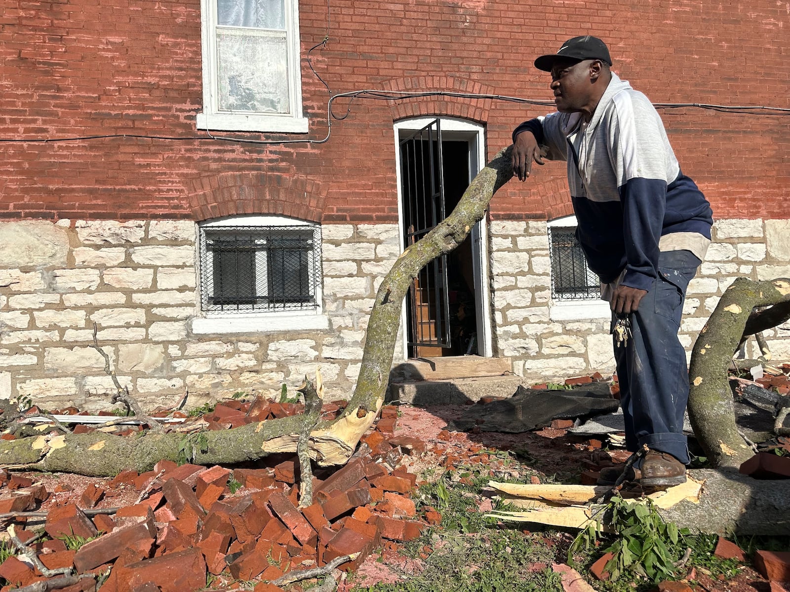 Greg Simmons, 55, a St. Louis resident, surveyed damage after a storm ripped the roof off of his home on Friday, May 16, 2025. (AP Photo/Michael Phillis)