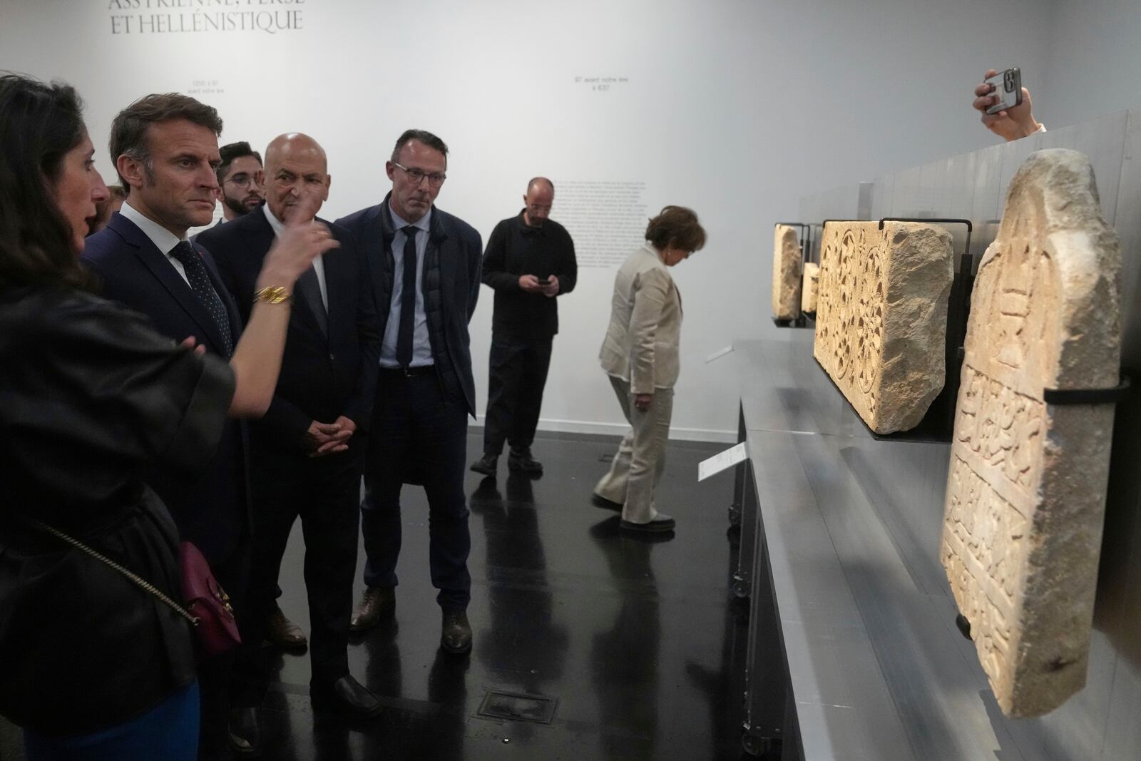 French President Emmanuel Macron, second left, listens to explanations as he visits the exhibition "Treasures rescued from Gaza" Monday, April 14, 2025 at the Arab World Institute (IMA) in Paris. (AP Photo/Michel Euler, Pool)