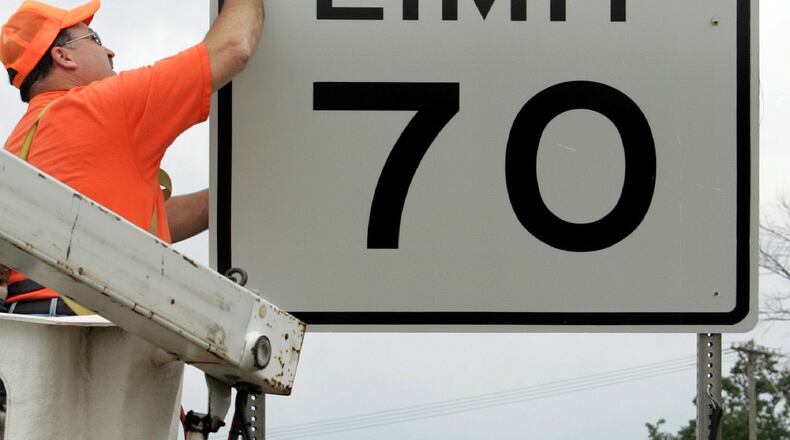 FILE - This July 5, 2005 photo shows Indiana Department of Transportation worker Jim Hargus installing one the the new 70 mph speed limit signs along Interstate 65 in Lebanon, Ind. Some lawmakers in the Ohio House want the state to join 32 others that have raised speed limits to 70 mph or higher on certain roads. A House transportation committee was scheduled to hold a hearing on the bill Wednesday, May 20, 2009. (AP Photo/Michael Conroy, File)