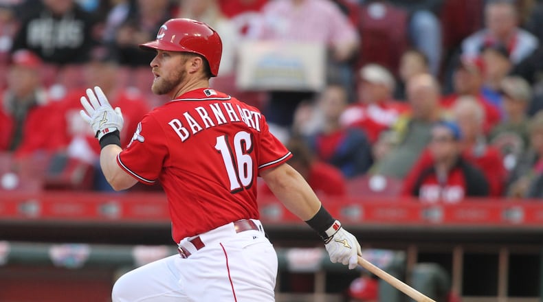 Reds catcher Tucker Barnhart swings against the Brewers on May 5, 2016, at Great American Ball Park in Cincinnati. David Jablonski/Staff