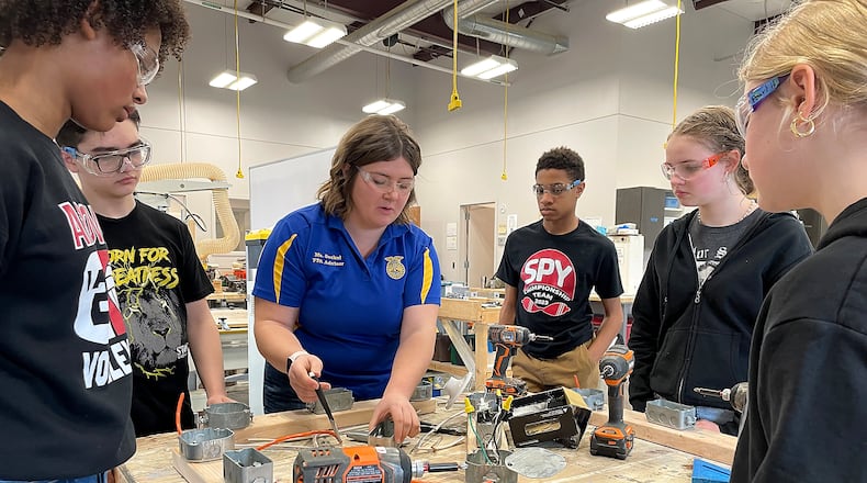 Trisha Seckel, an Ag teacher at the Global Impact STEM Academy, teaches a group of students basic electrical wiring techniques during a class Friday, March 8, 2024. BILL LACKEY/STAFF