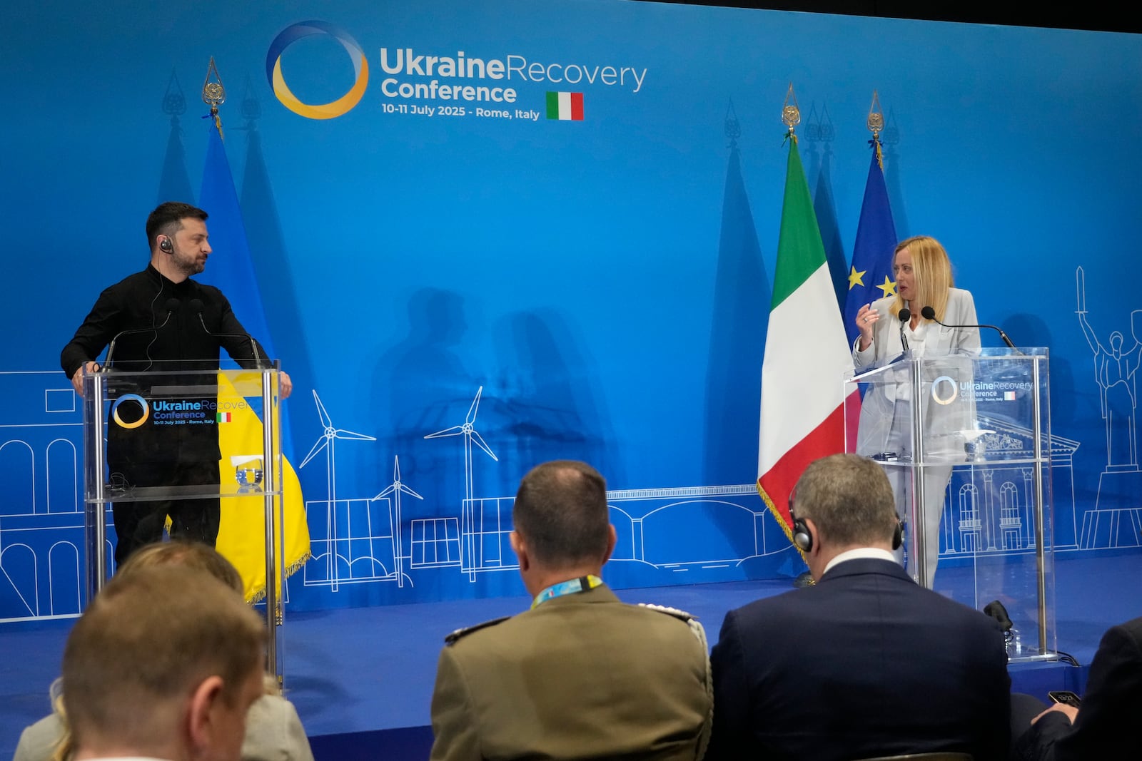 Ukraine's President Volodymyr Zelenskyy and Italian Prime Minister Giorgia Meloni speak with media reporters during the Ukraine Recovery Conference at La Nuvola convention center in Rome, Thursday, July 10, 2025. (AP Photo/Gregorio Borgia)