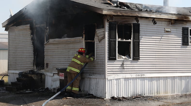 German and Pike Township fire departments battle a mobile home fire at Chateau Estates Mobile Home Park on Folk Ream Road Thursday. Bill Lackey/STAFF PHOTO