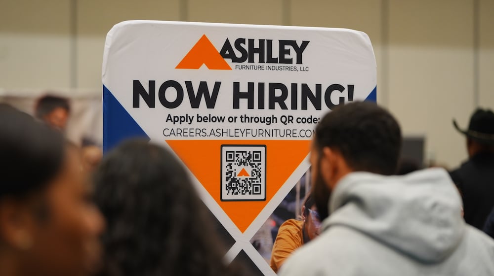 FILE - A sign with information about employment is displayed during a job fair in Dallas, Jan. 14, 2026. (AP Photo/LM Otero, File)