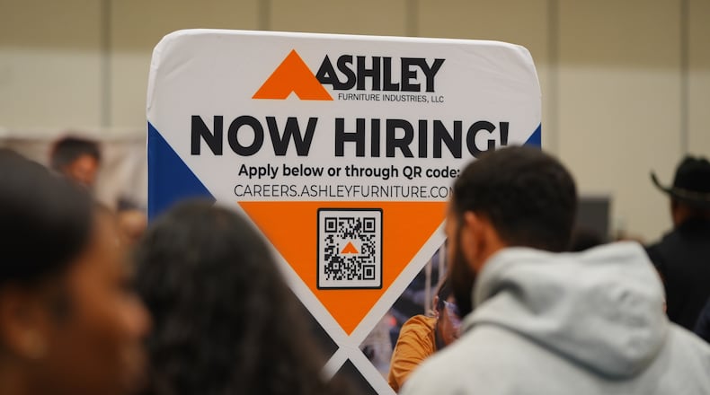 FILE - A sign with information about employment is displayed during a job fair in Dallas, Jan. 14, 2026. (AP Photo/LM Otero, File)