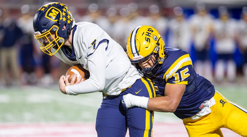 Springfield High School junior Jackson Heims sacks Moeller sophomore Matt Ponatoski during a Division I state semifinal game on Friday night at Piqua Alexander Stadium. Michael Cooper/CONTRIBUTED