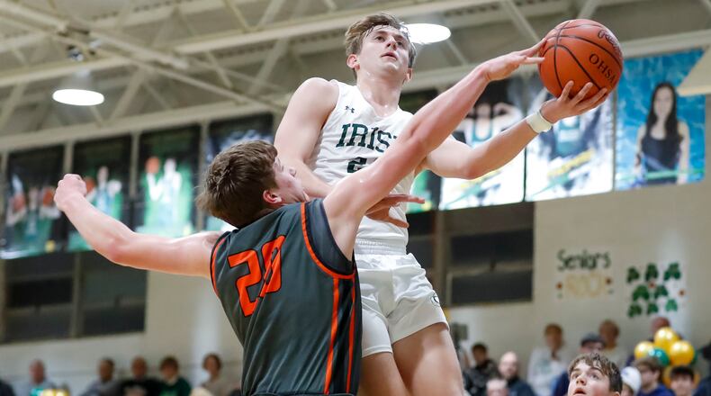 Catholic Central senior Tyler Galluch drives to the hoop as West Liberty-Salem freshman Carson Poppe reaches out for the ball during their game at Jason Collier Gymnasium on Jan. 17, 2023. The Irish won 61-48. Michael Cooper/CONTRIBUTED