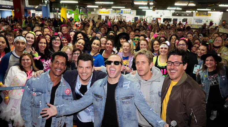 New Kids On The Block members, from left, Danny Wood, Jordan Knight, Donnie Wahlberg, Joey McIntyre and Jonathan Knight pose with fans at an 80's style roller rink party to celebrate their new single, at South Amboy Arena Rollermagic, on Thursday, March 3, 2022, in New Jersey. (Photo by Charles Sykes/Invision/AP)