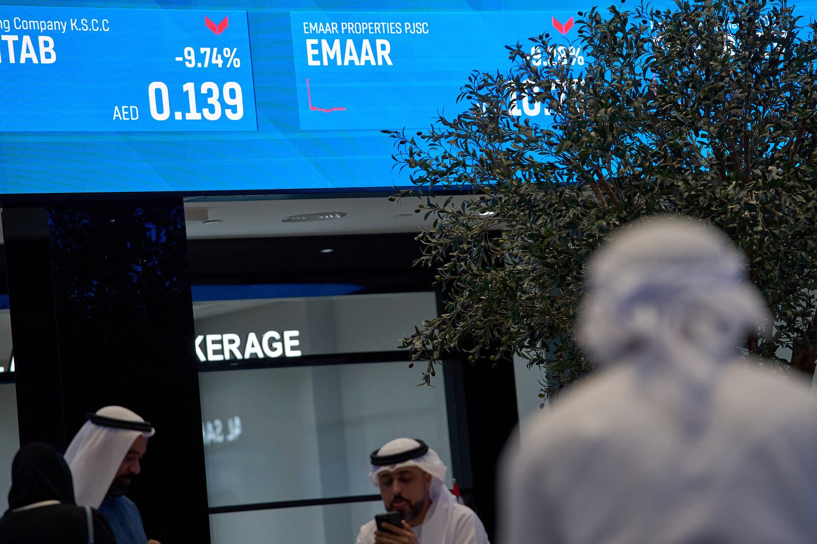Emiratis are seen in the Dubai Financial Market in Dubai, United Arab Emirates, Monday, April 7, 2025. (AP Photos/Fatima Shbair)