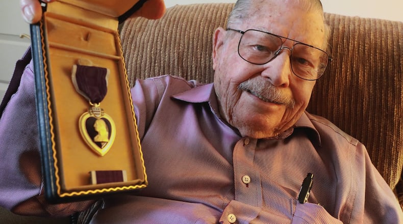 D-Day veteran Albert Carr is very proud of the Purple Heart medal he received during WWII. Carr was shot twice during he service in the war. BILL LACKEY/STAFF