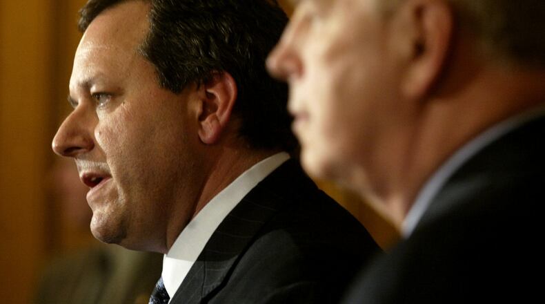 Marc Dann (left) resigned as attorney general of Ohio Wednesday May 14 in Columbus with Gov. Ted Strickland (right) at his side. Staff photo by Lisa Powell
