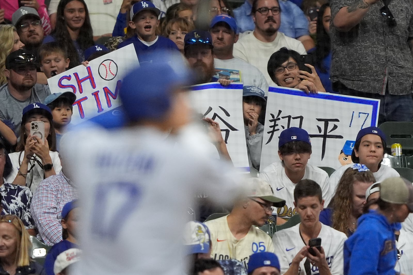 Fans cheer as Los Angeles Dodgers' Shohei Ohtani bats during the eighth inning of a baseball game against the Milwaukee Brewers, Monday, July 7, 2025, in Milwaukee. (AP Photo/Aaron Gash)